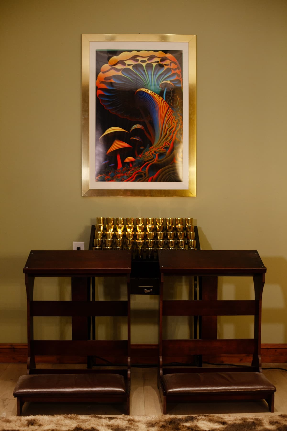 Chapel pews beneath framed mushroom artwork inside The Living Church